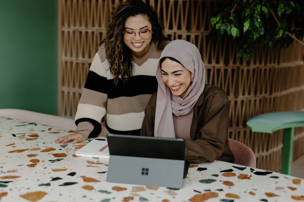 The Role of Communication in Company Culture, two professional women discuss work.